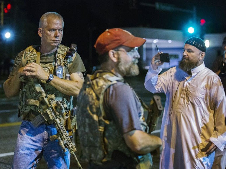 Members of the Oath Keepers were seen walking among protesters while carrying high-powered guns.