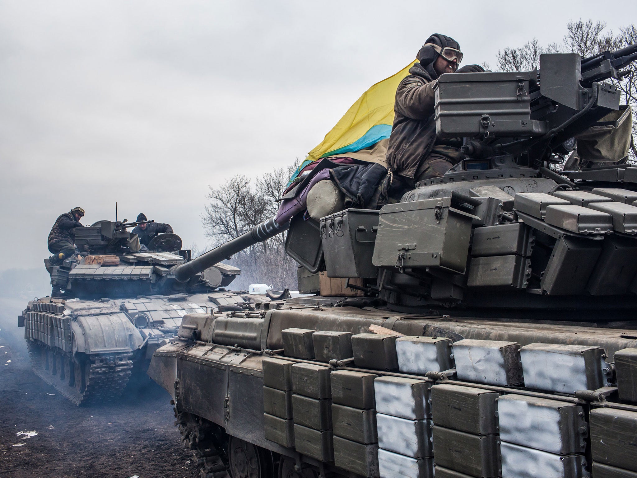 Ukrainian soldiers drive tanks along the road leading out of Debaltseve on February 19, 2015 in Artemivsk, Ukraine