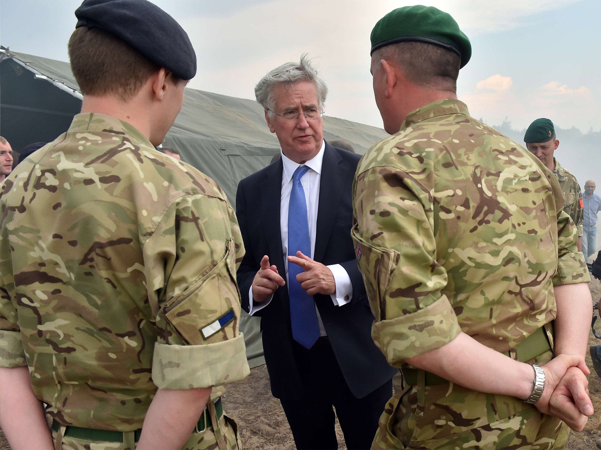 Defence Secretary Michael Fallon speaking with British military instructors after exercises near Ghytomyr, Ukraine (Getty)