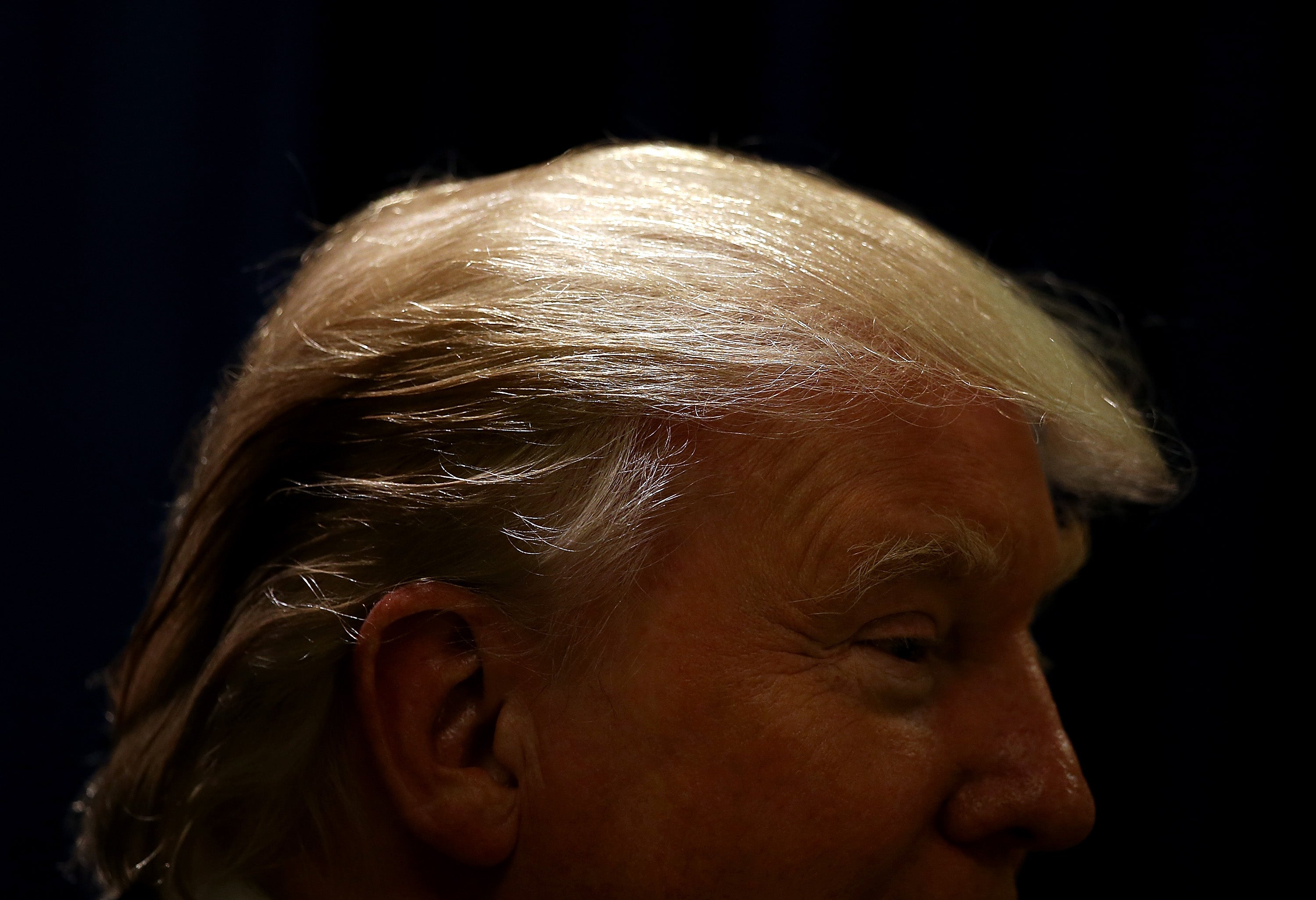 Trump's hair glistens before a press conference at the Republican Leadership Conference (Getty)