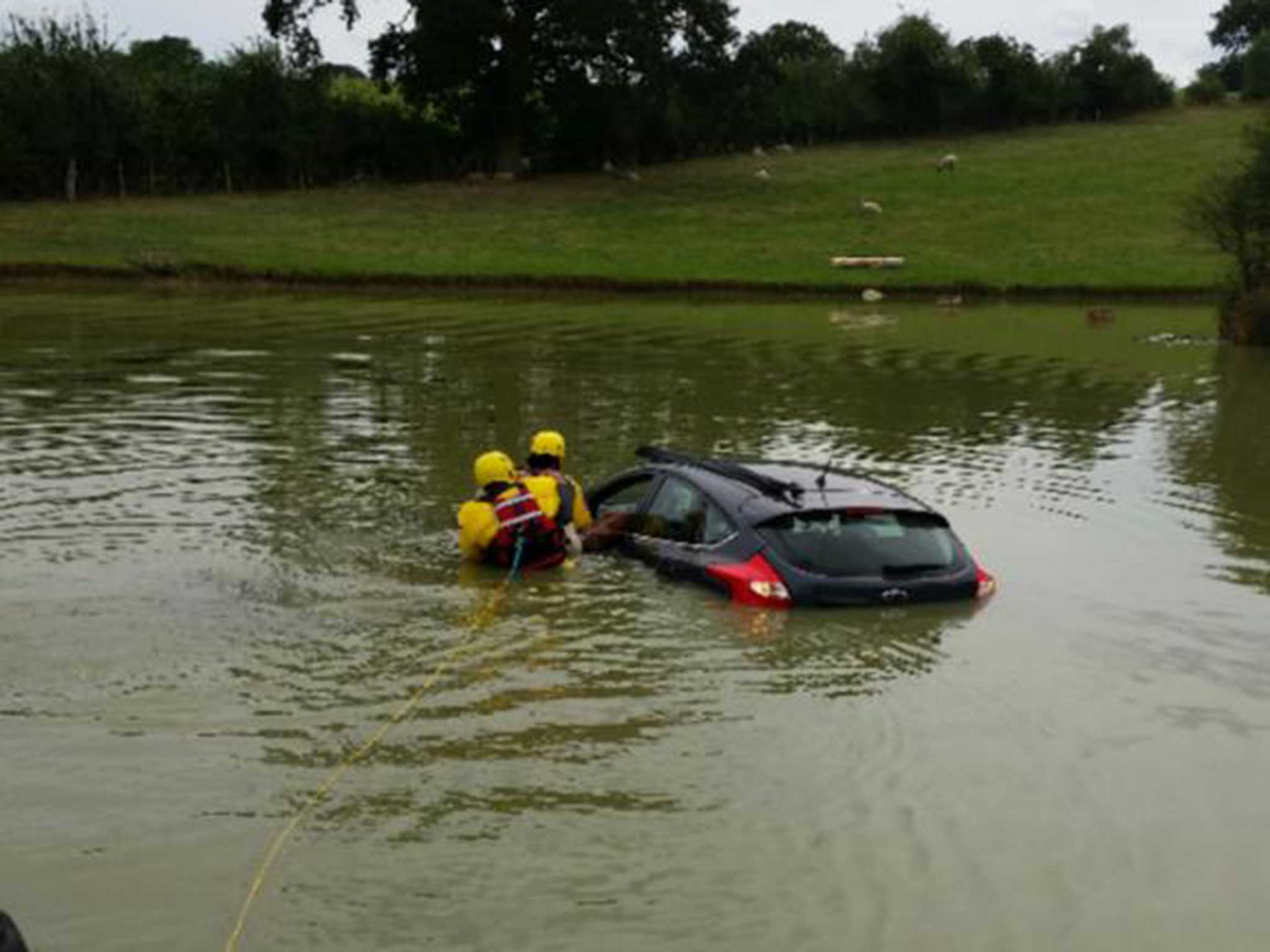 Firefighters rescue the man from his car