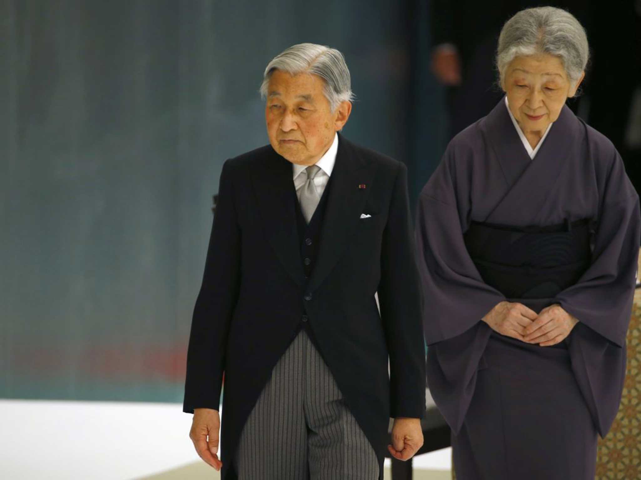 Japan's Emperor Akihito, accompanied by Empress Michiko, leaves after delivering his remarks