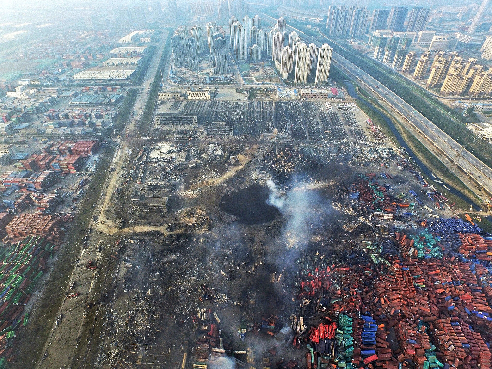 A huge hole in the ground at the north-eastern port city of Tianjin, China. An exclusion zone of 3km has been placed around the site, displacing 6,300 people