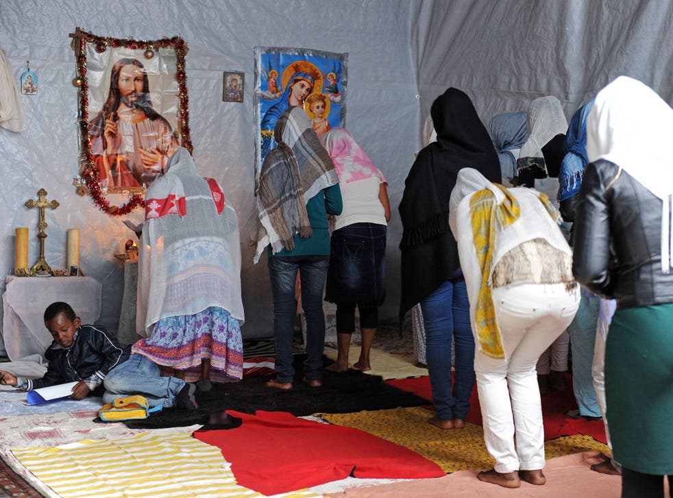 Migrants attend mass at the makeshift Calais church featured on 'Songs of Praise'
