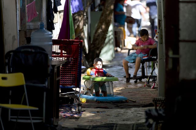 Children sit in a walkway inside the Samaritan shantytown. Volunteer groups have offered to improve sanitation and safety in the settlement but the council says their plans are not viable