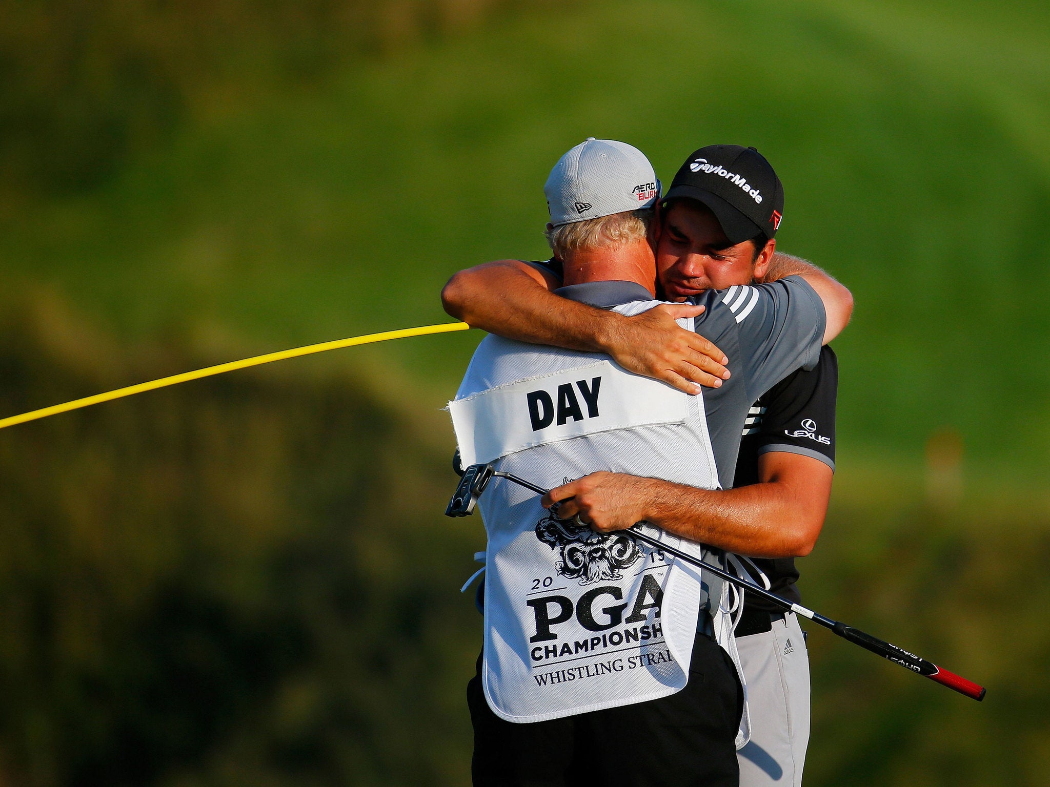 Day was embraced by his caddie and mentor Col Swatton