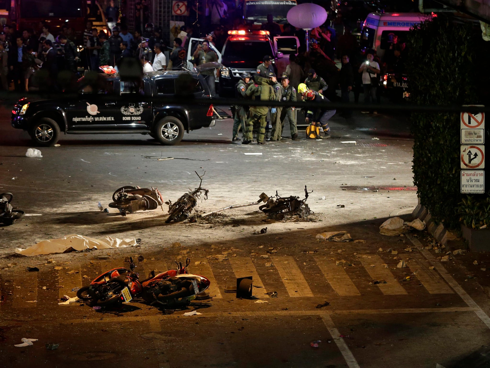Motorcycles lie on the street at the scene of the bomb attack near Erawan Shrine -