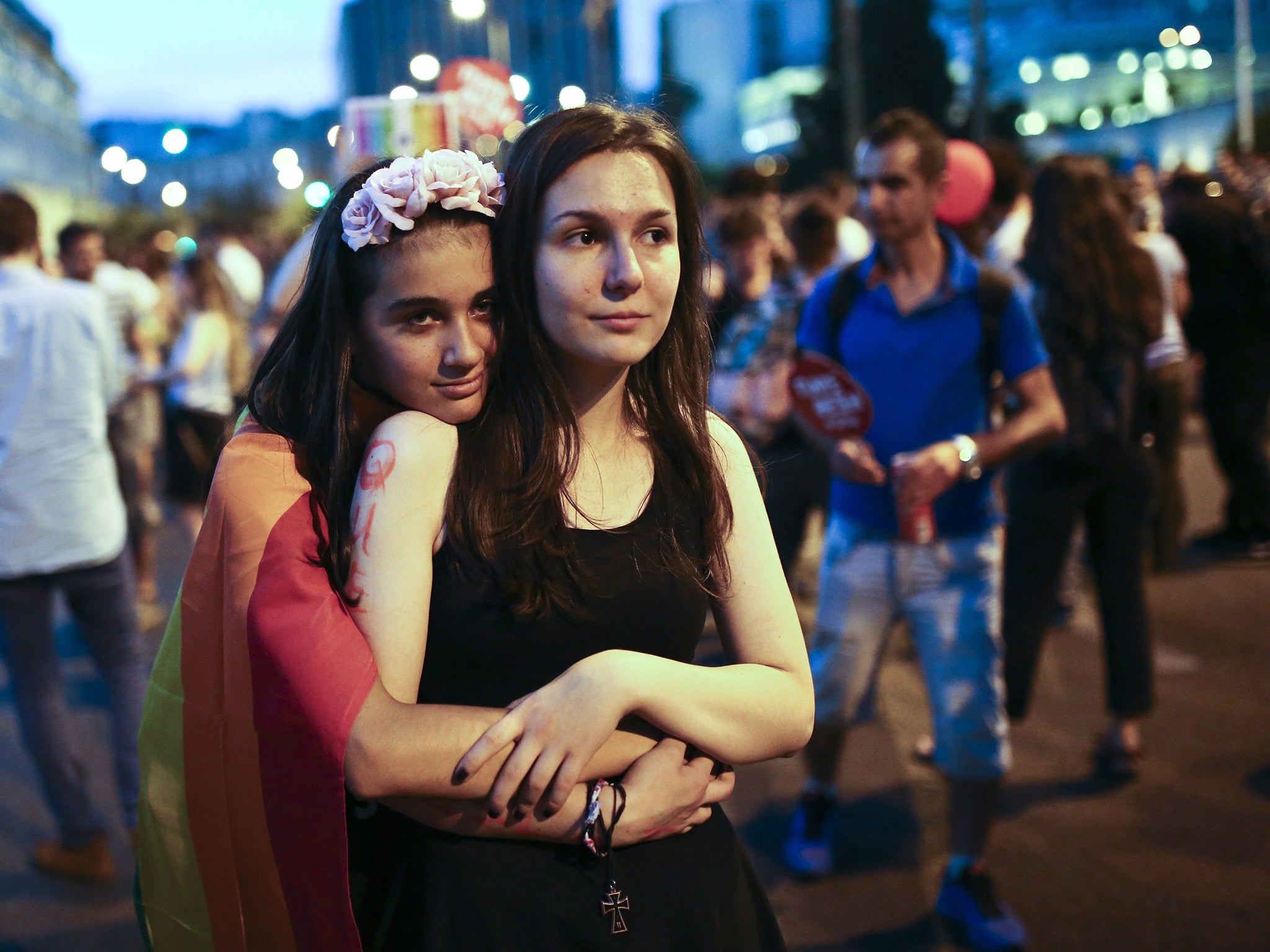 Two women hug in front of the Greek Parliament in Athens during a Gay Pride parade