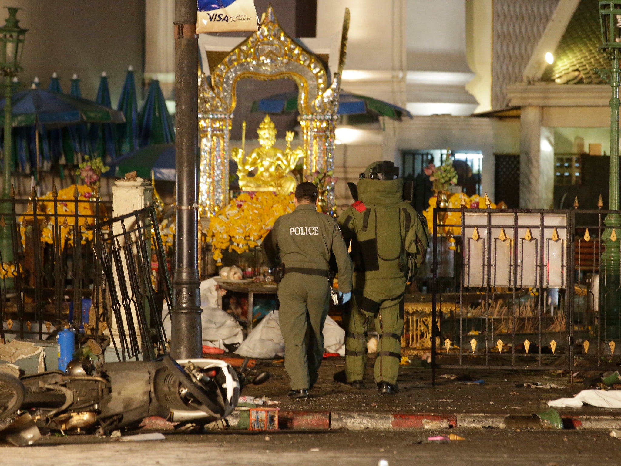 Explosive Ordnance Disposal officers enter the Erawan Shrine after the explosion