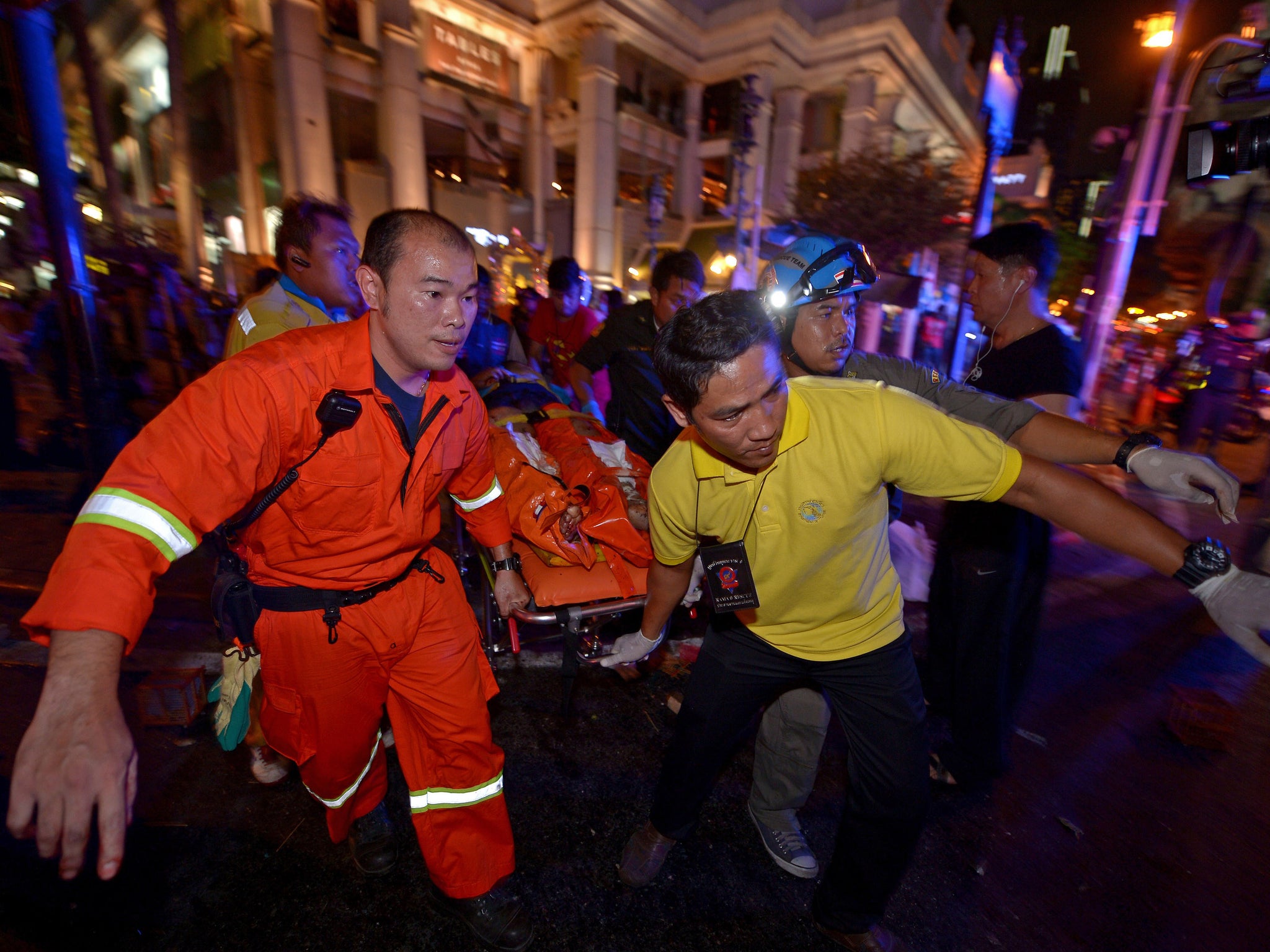 Thai rescue workers carry an injured person away from the scene - (EPA)