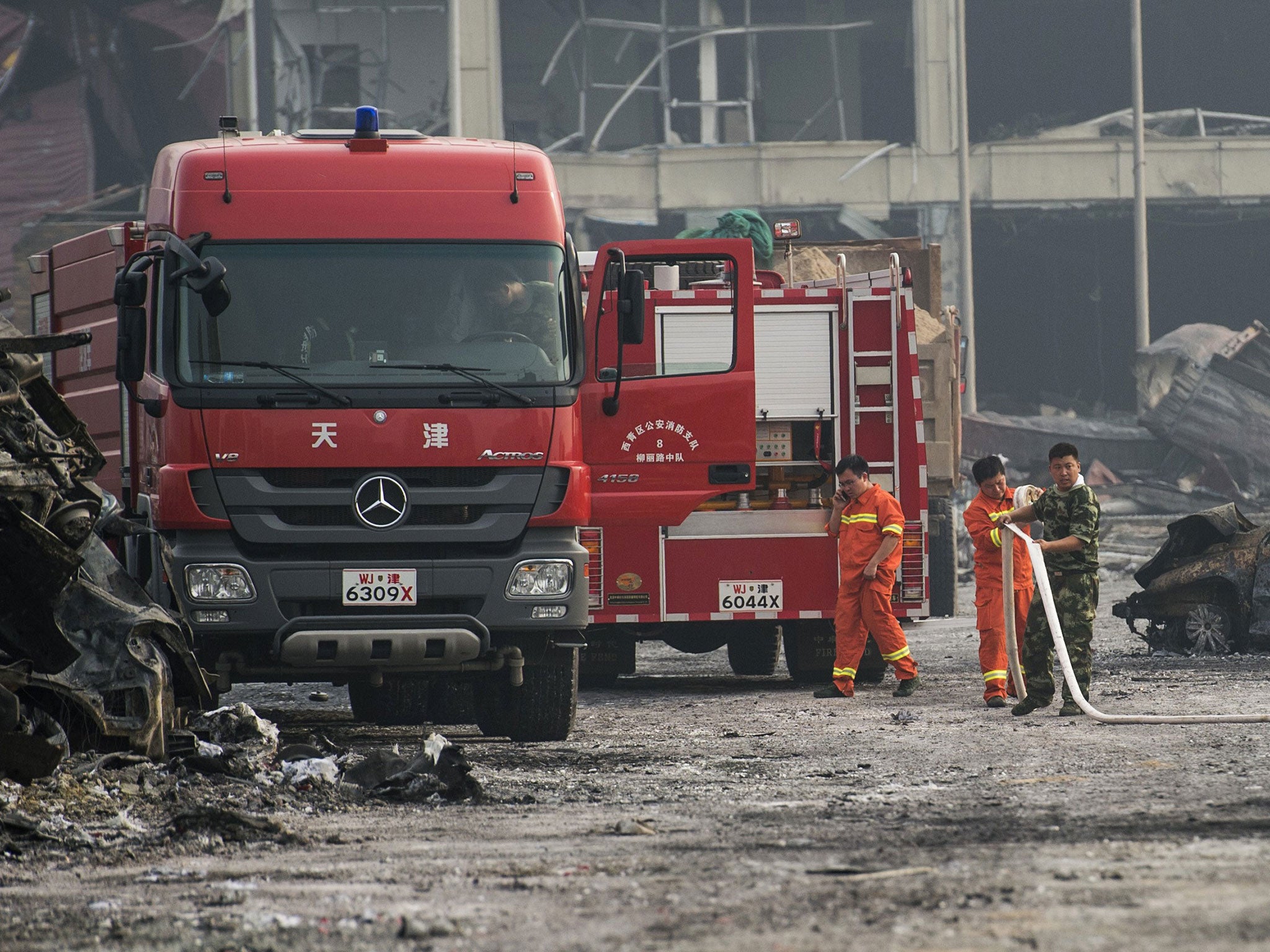 Chinese firefighters continue operations after a series of explosions at a chemical warehouse hit the city of Tianjin, in northern China