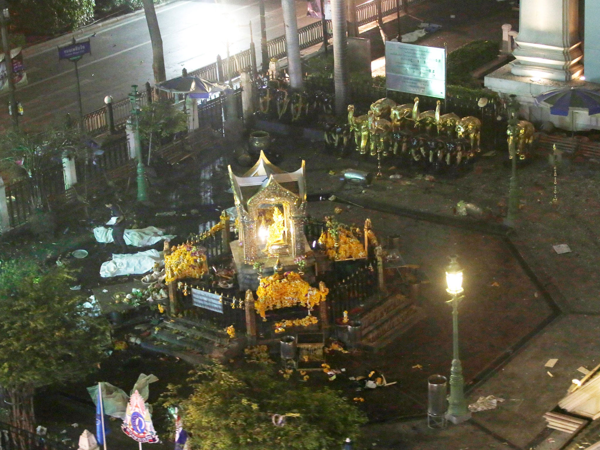 A general view taken from a moving train shows the scene at the Erawan Shrine after a bomb explosion in central Bangkok, Thailand