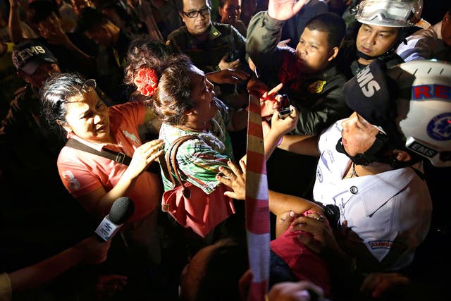 People search for missing relatives near Erawan Shrine after the explosion in the Thai capital