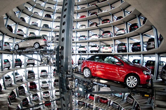 A VW Passat, left, and a Golf Cabrio car wait in the storage building of the Volkswagen company in Wolfsburg, Germany