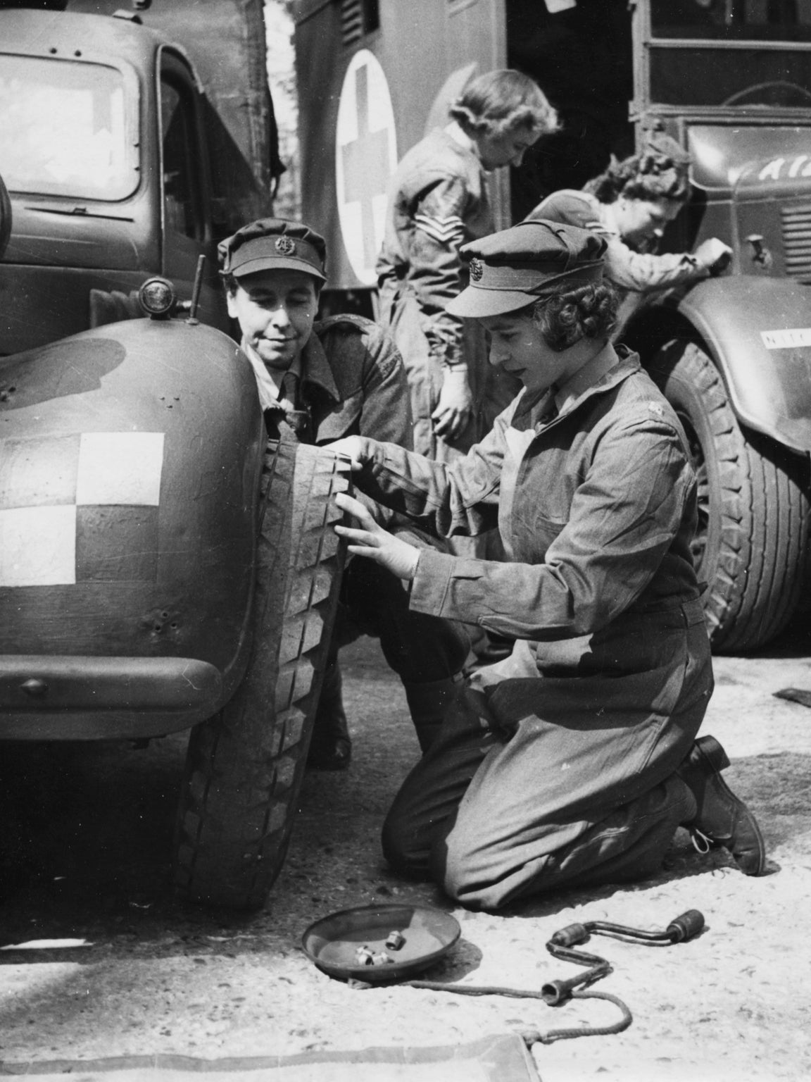 Just before the end of the war Elizabeth took part in training to become an ATS officer. She is pictured learning to change a tire, 1945