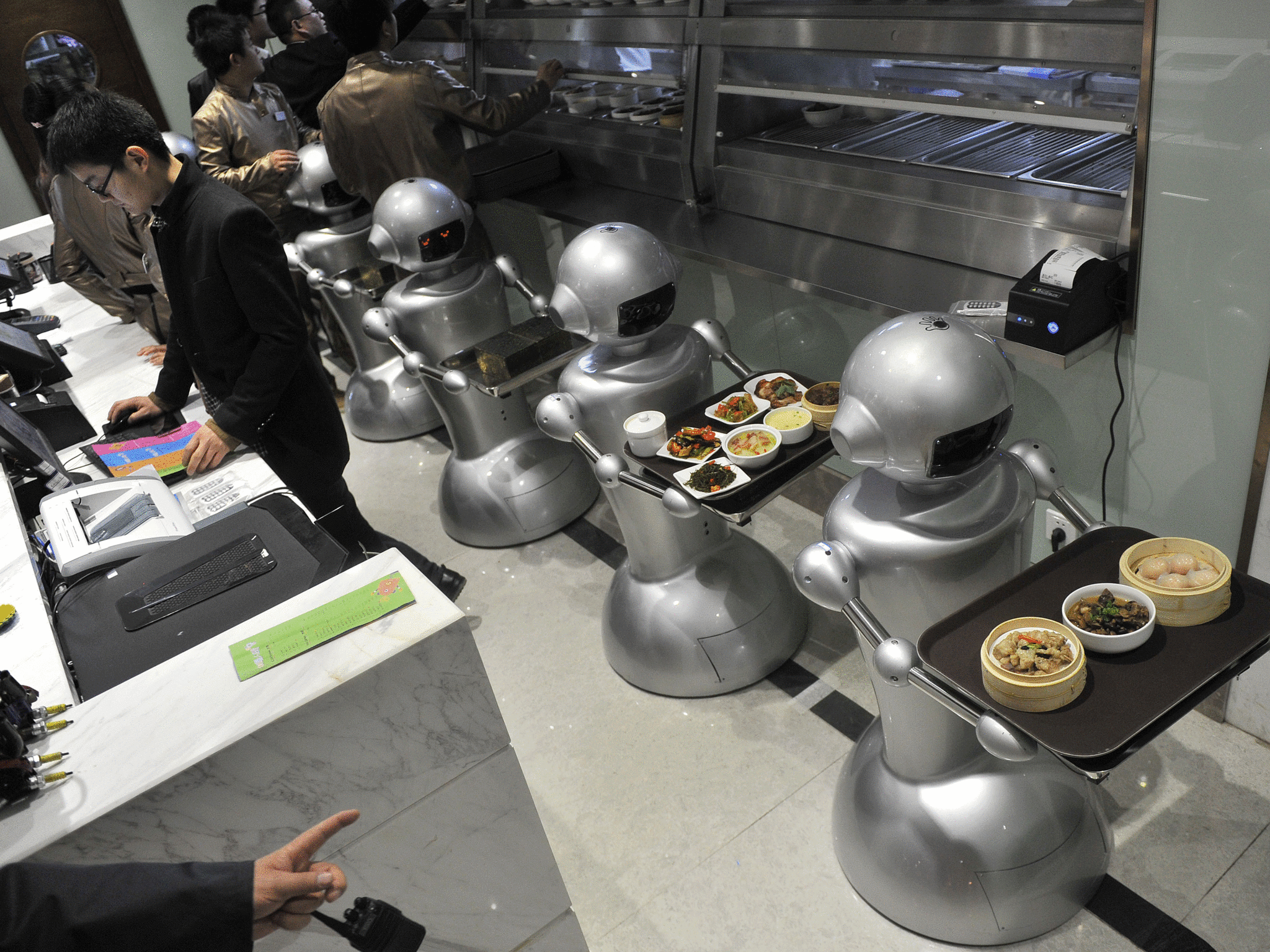 Robots wait to serve customers at a restaurant in China