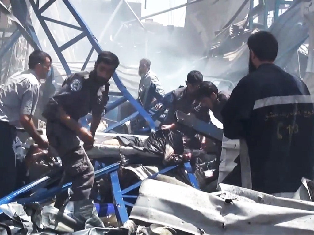 Rescuers carry a victim from the site of Syrian government airstrikes in Douma, a suburb of Damascus