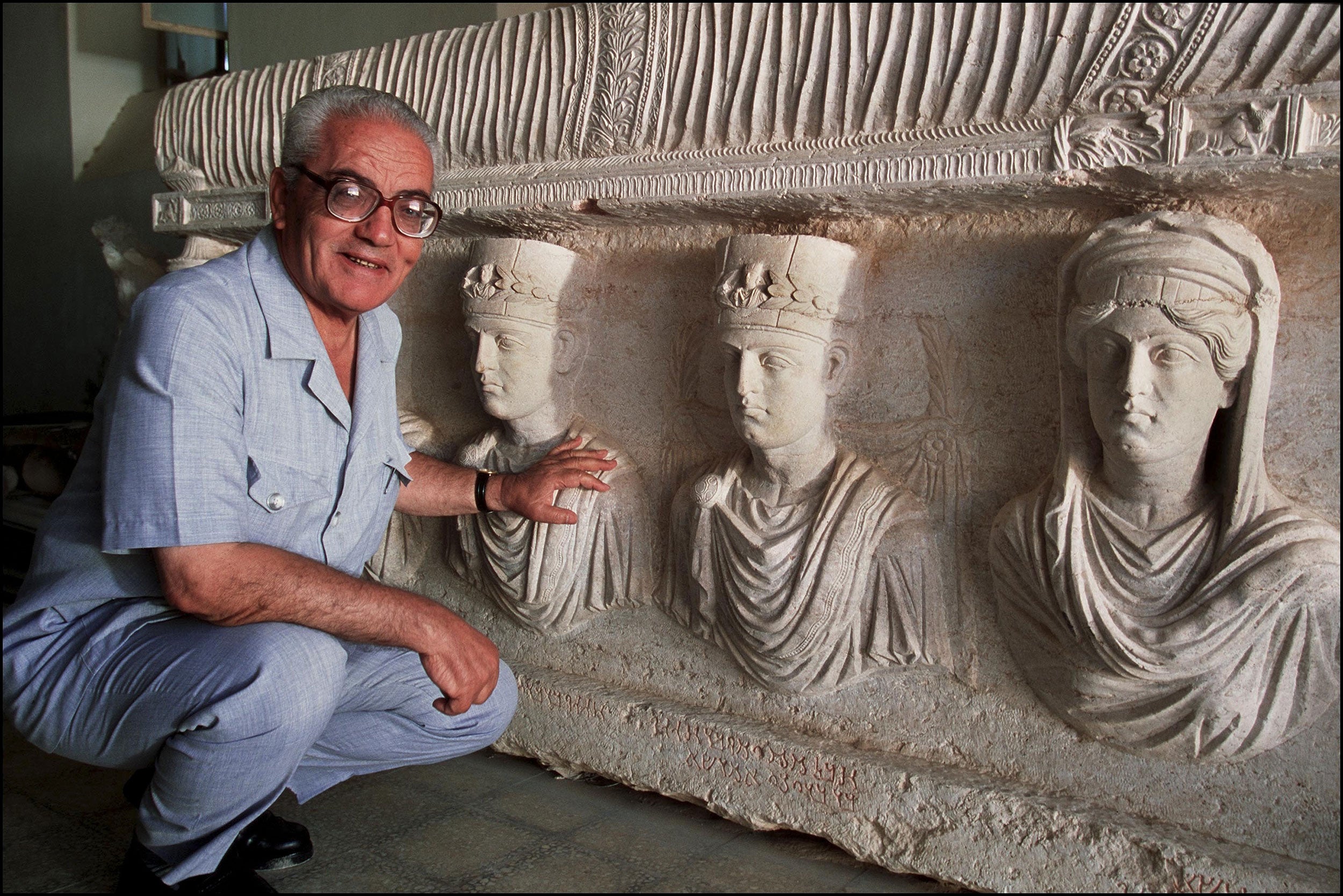 Khaled Asaad, the Director of Antiquities and Museum in Palmyra, in front of a rare 1st century sarcophagus, one of the finest sculptures in Palmyra