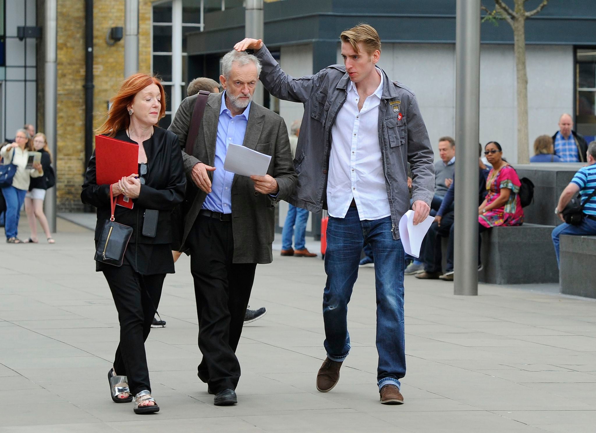 Jeremy Corbyn's son Sebastian pats his father's head before a rally in King's Cross station in London