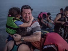 Refugee crisis: Father photographed crying with children in Kos has reached Germany