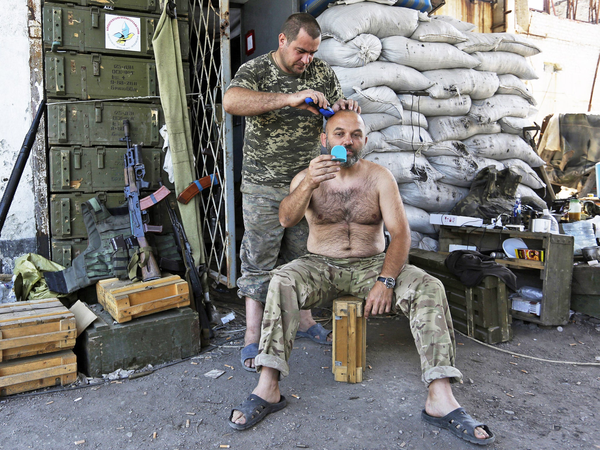 A soldier gets a trim at a position held by Ukrainian forces at the destroyed Butovka mine near Donetsk airport (Getty)