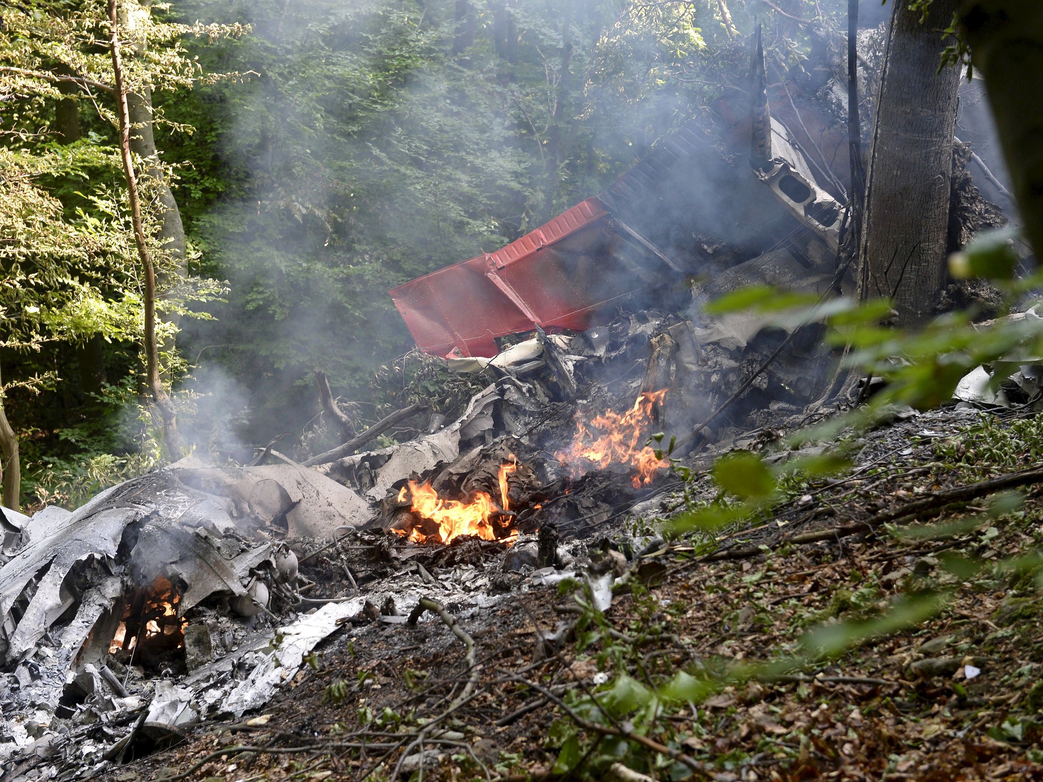 The smoking wreckage is seen on the forest floor, 7 people have died in the accident