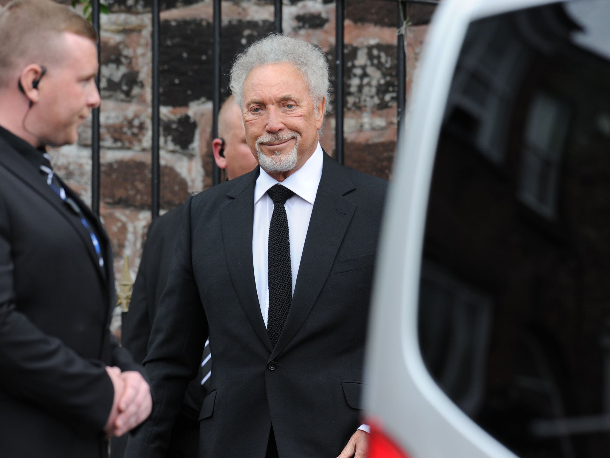 Sir Tom Jones arrives for the funeral of Cilla Black