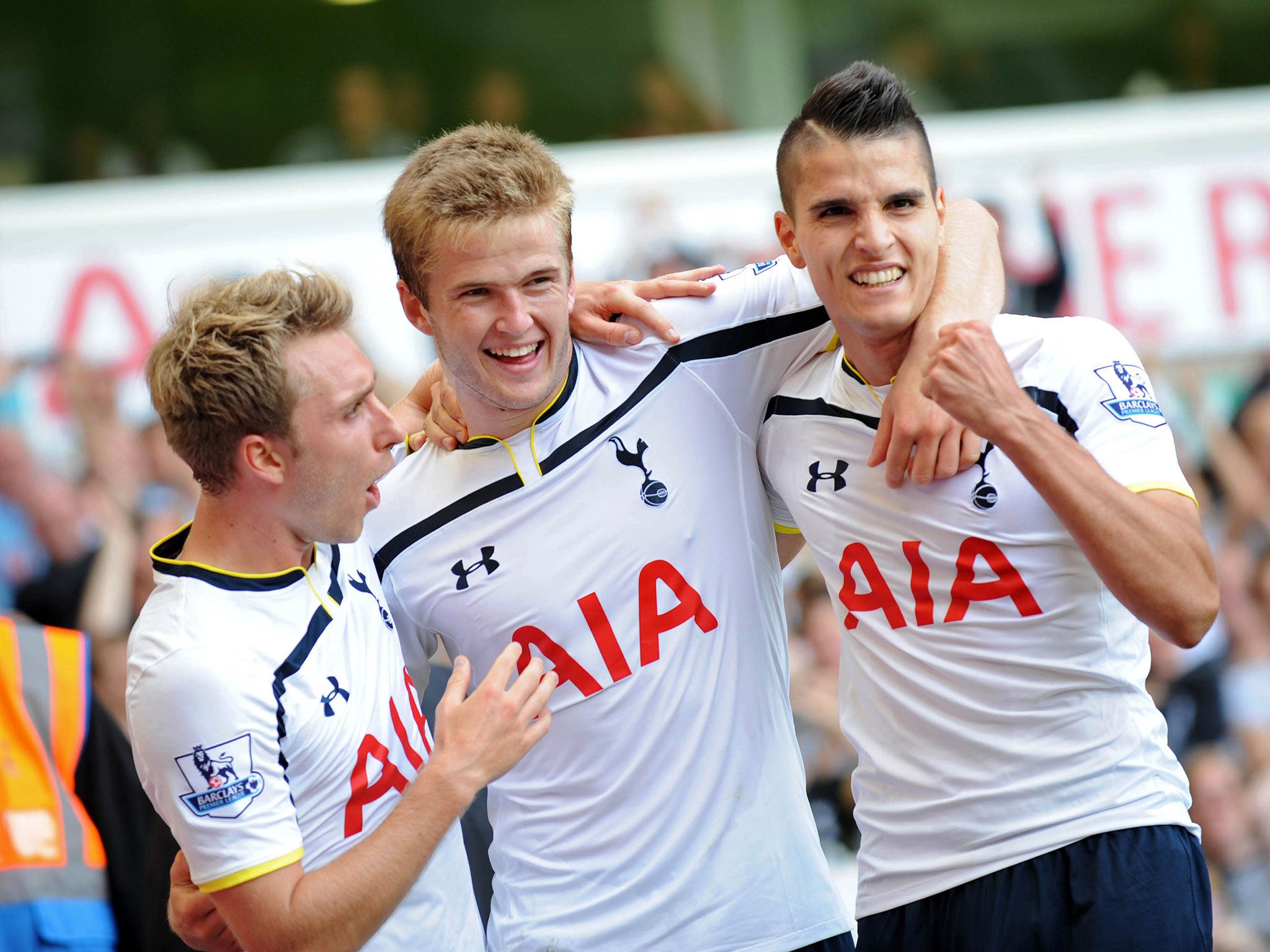 Christian Eriksen and Erik Lamela celebrate with Eric Dier after his goal