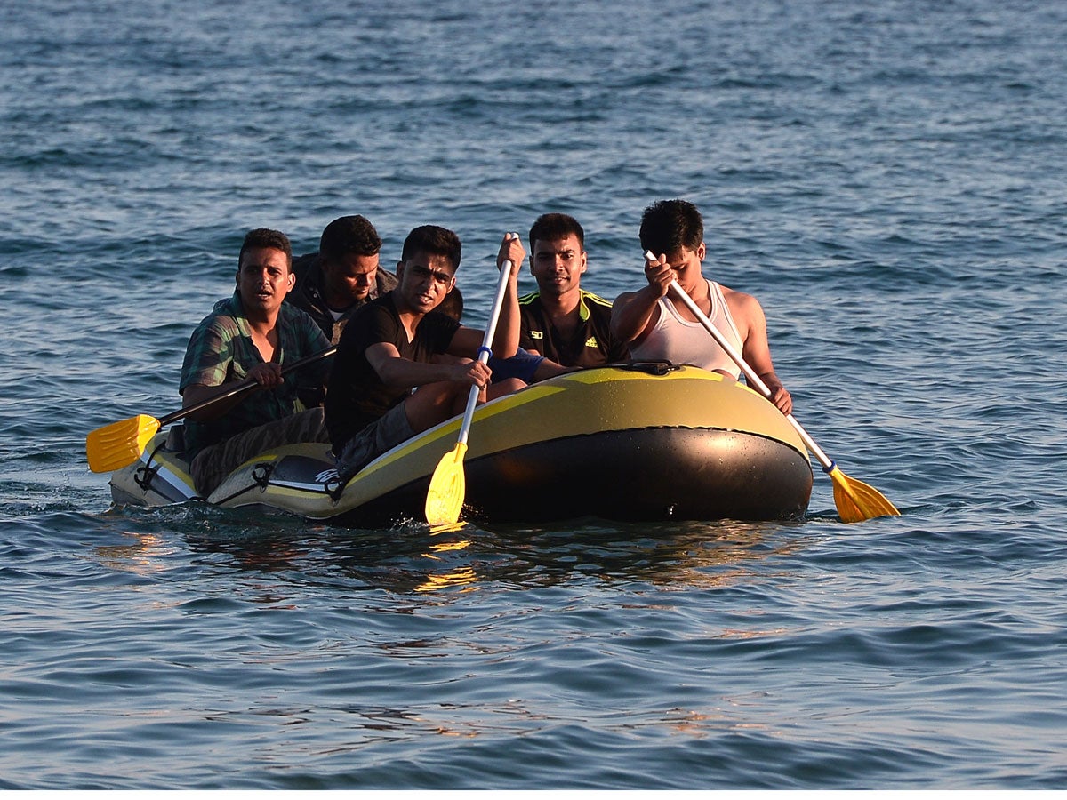 A group of migrants arrive to the shore of Kos island on a small dinghy from Turkey