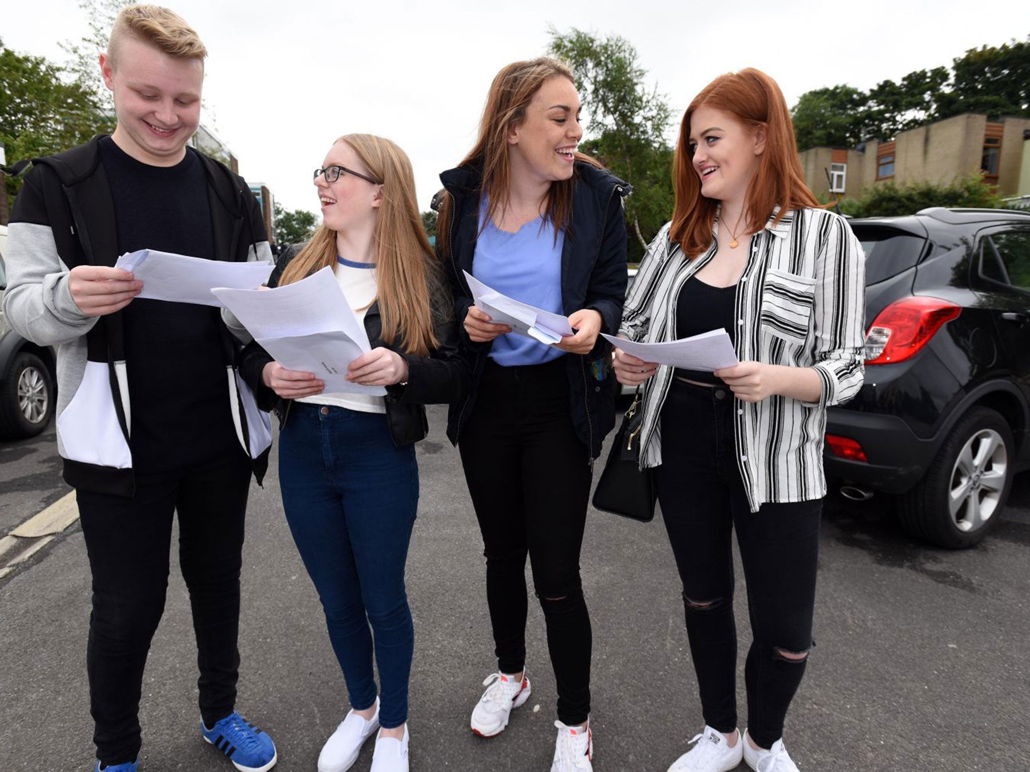 Emily Mott, 16, (second from left) receives her GCSE results at Royton and Crompton High School, Oldham.