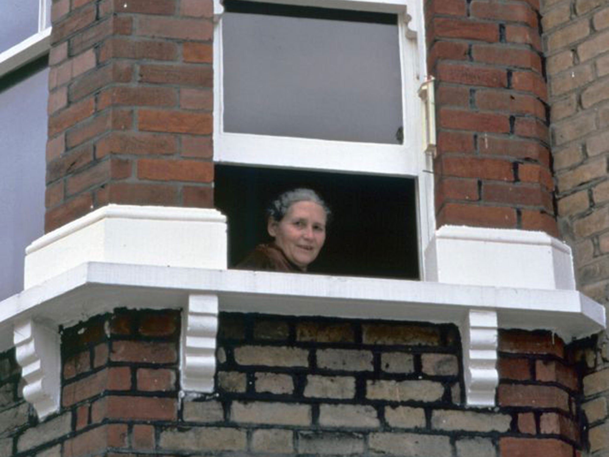 Doris Lessing looking out the window of her London flat (AFP)