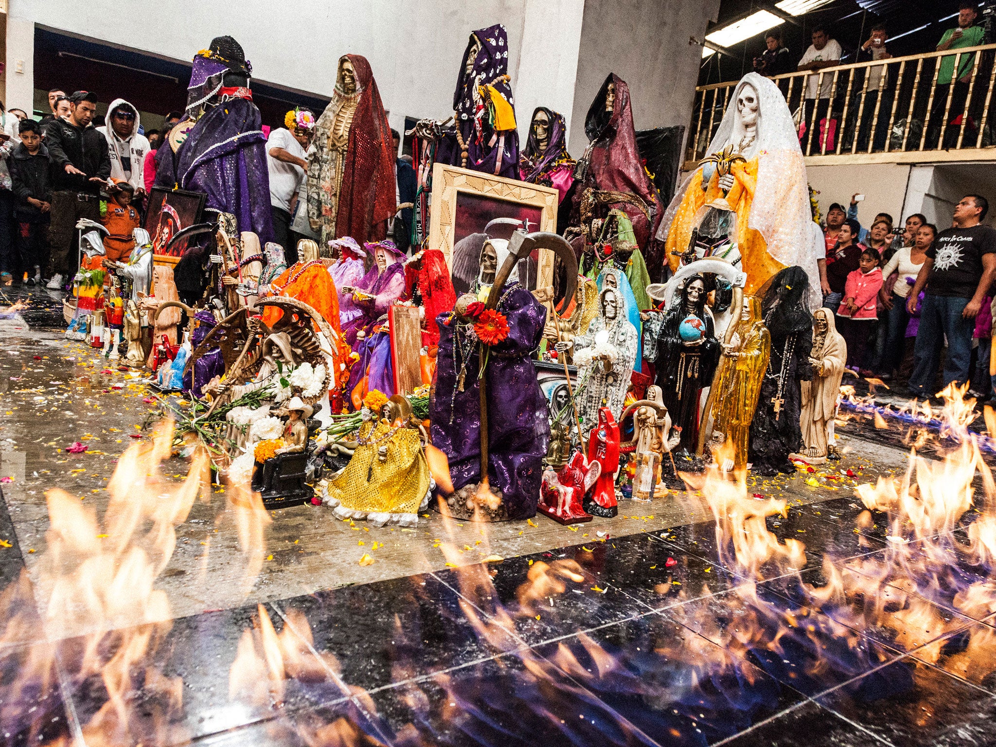 'Baptism of Fire, Pachuca, Mexico' - Santa Muerte statuettes are consecrated and baptised with tequila then set alight