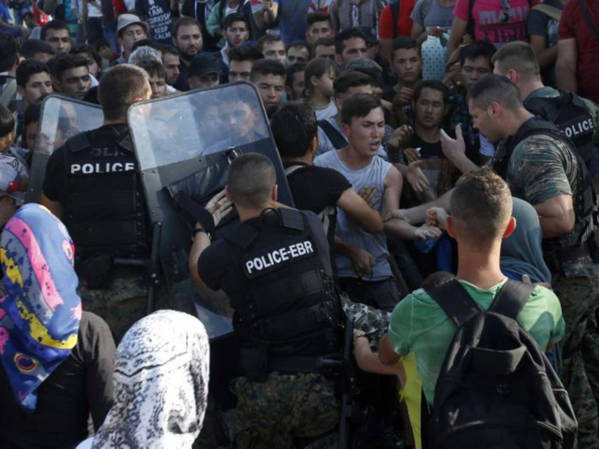 Police and migrants grapple on the border town of Gevgelija, southern Macedonia