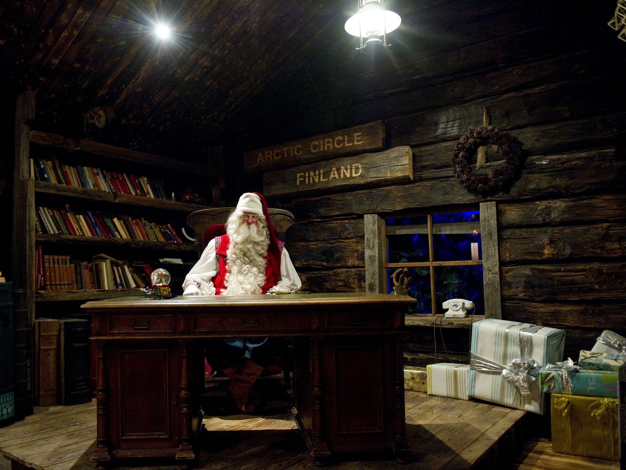 Santa Claus sits at his desk in his office in the Santa Park near Rovaniemi, Finnish Lapland, on December 14, 2011