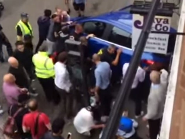 Amateur footage shows moment crowd lift car to free trapped woman in Oxford