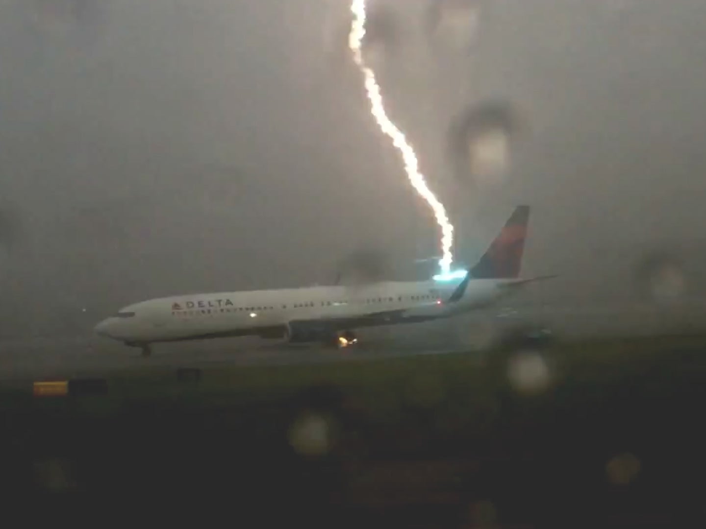 The exact moment a lightning strikes an airplane on the tarmac in Georgia