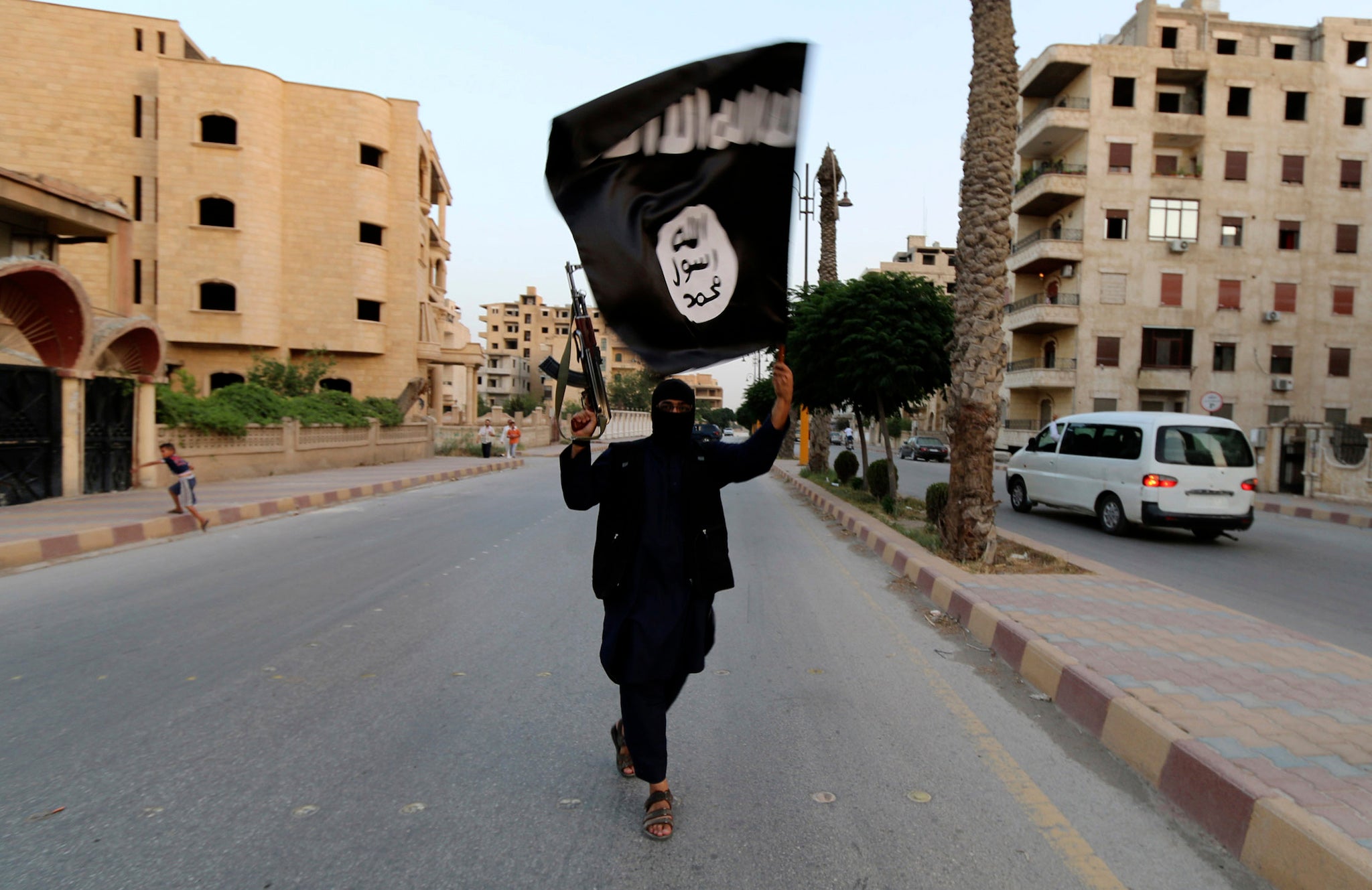 An Isis supporters carries the group's flag