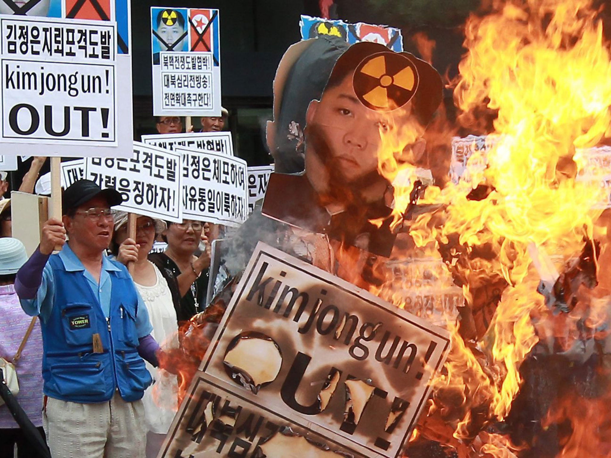 South Korean activists burn effigies of North Korea's leader Kim Jong-Un with flag in Seoul