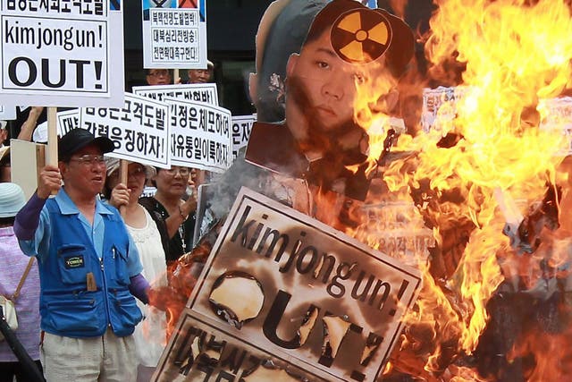 South Korean activists burn effigies of North Korea's leader Kim Jong-Un with flag in Seoul