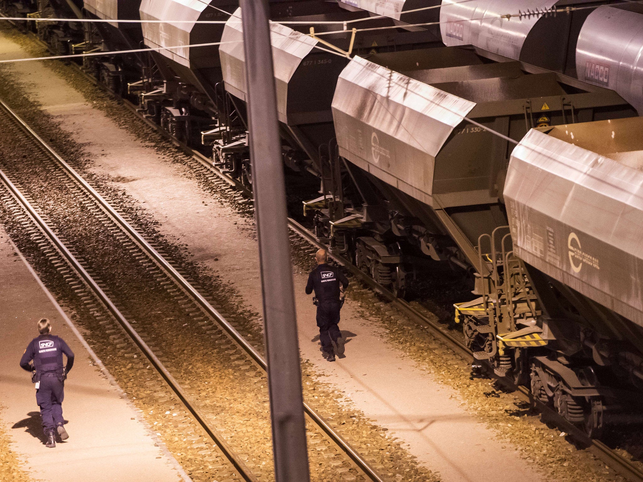 Security agents patrol a Eurotunnel train yard in Calais