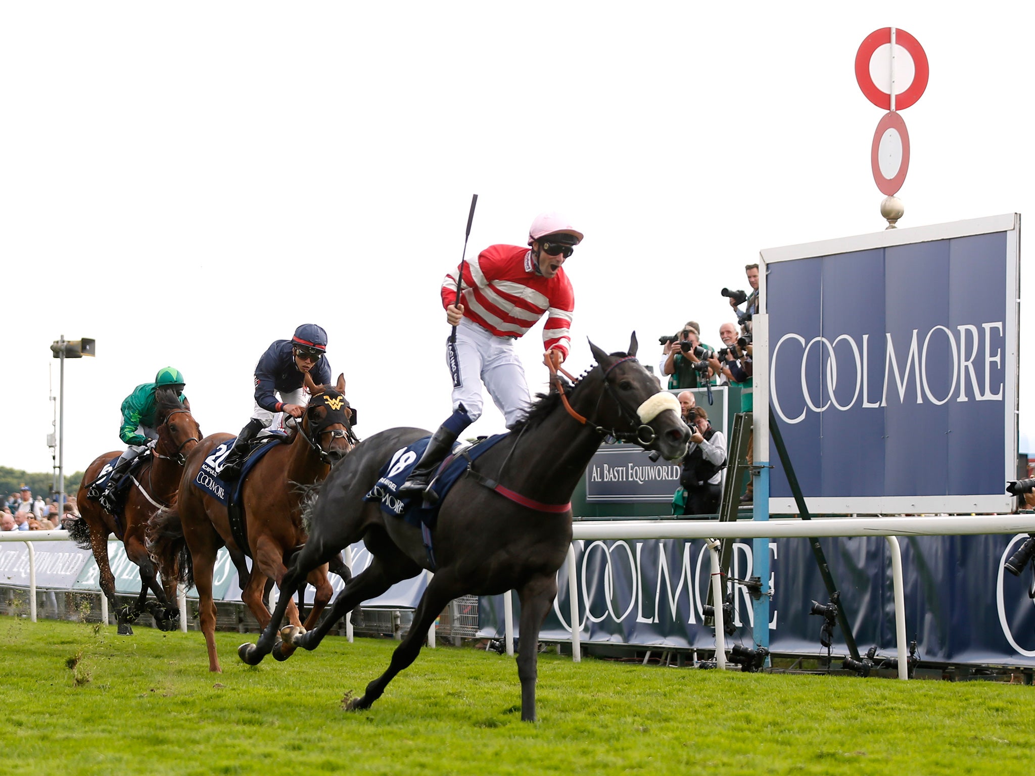 Paul Mulrennan raises his whip in triumph on Mecca’s Angel after chasing down Acapulco in the Nunthorpe Stakes at York