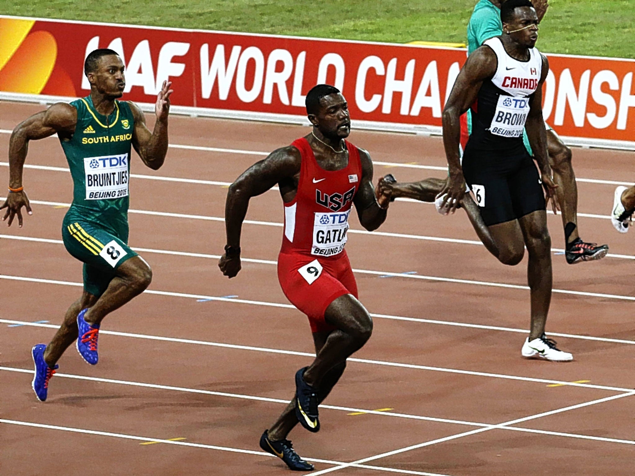 Justin Gatlin (centre) wins his 100m heat yesterday at the World Championships in Beijing