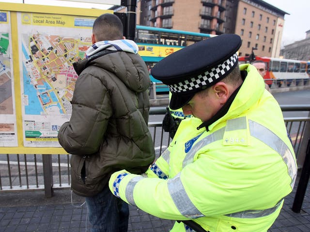 Police officers, combating potential knife-crime, stop and search people arriving in Liverpool