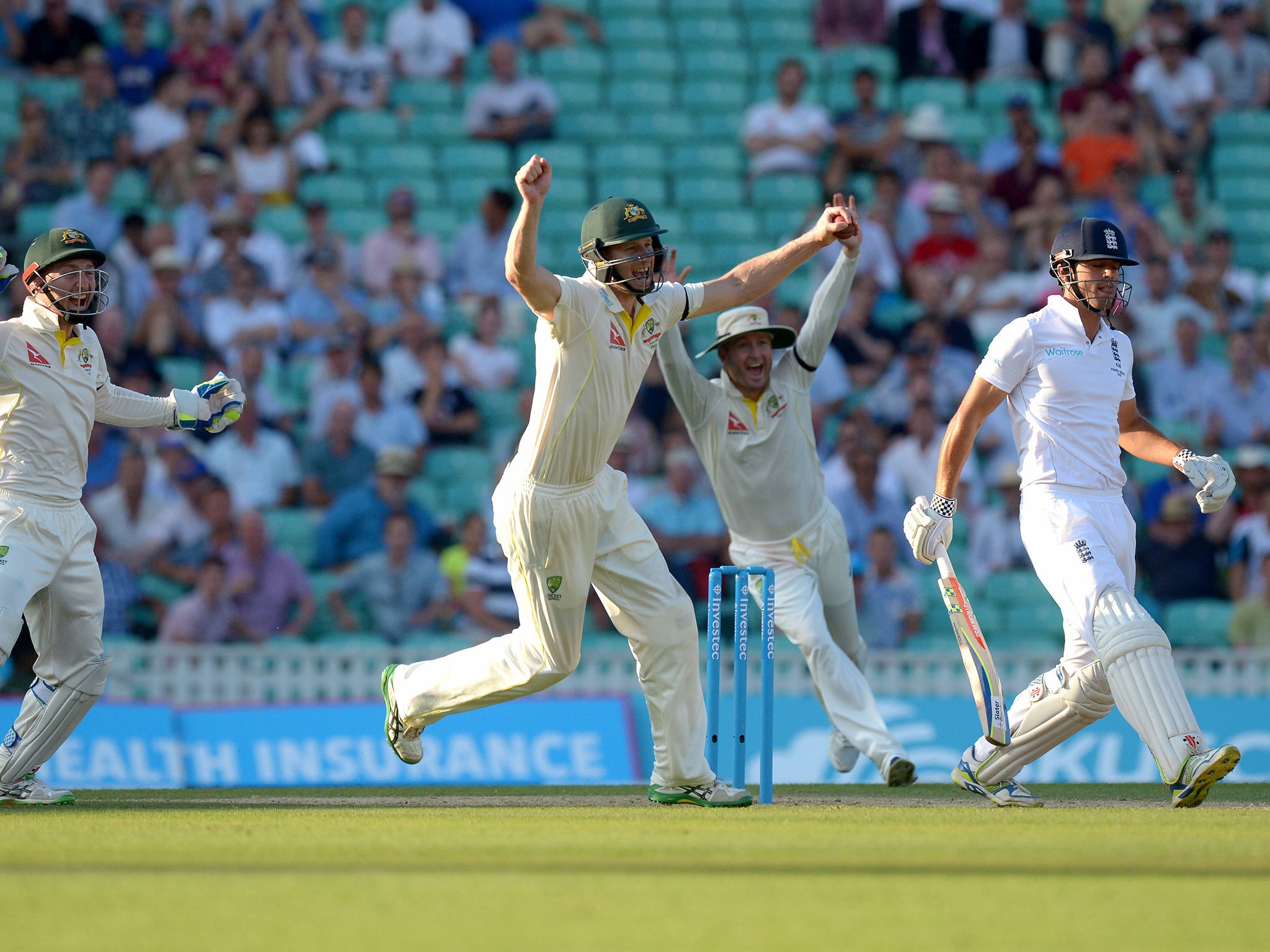 Australia celebrate as England captain Alastair Cook is dismissed by the part-time leg spin  of Steve Smith