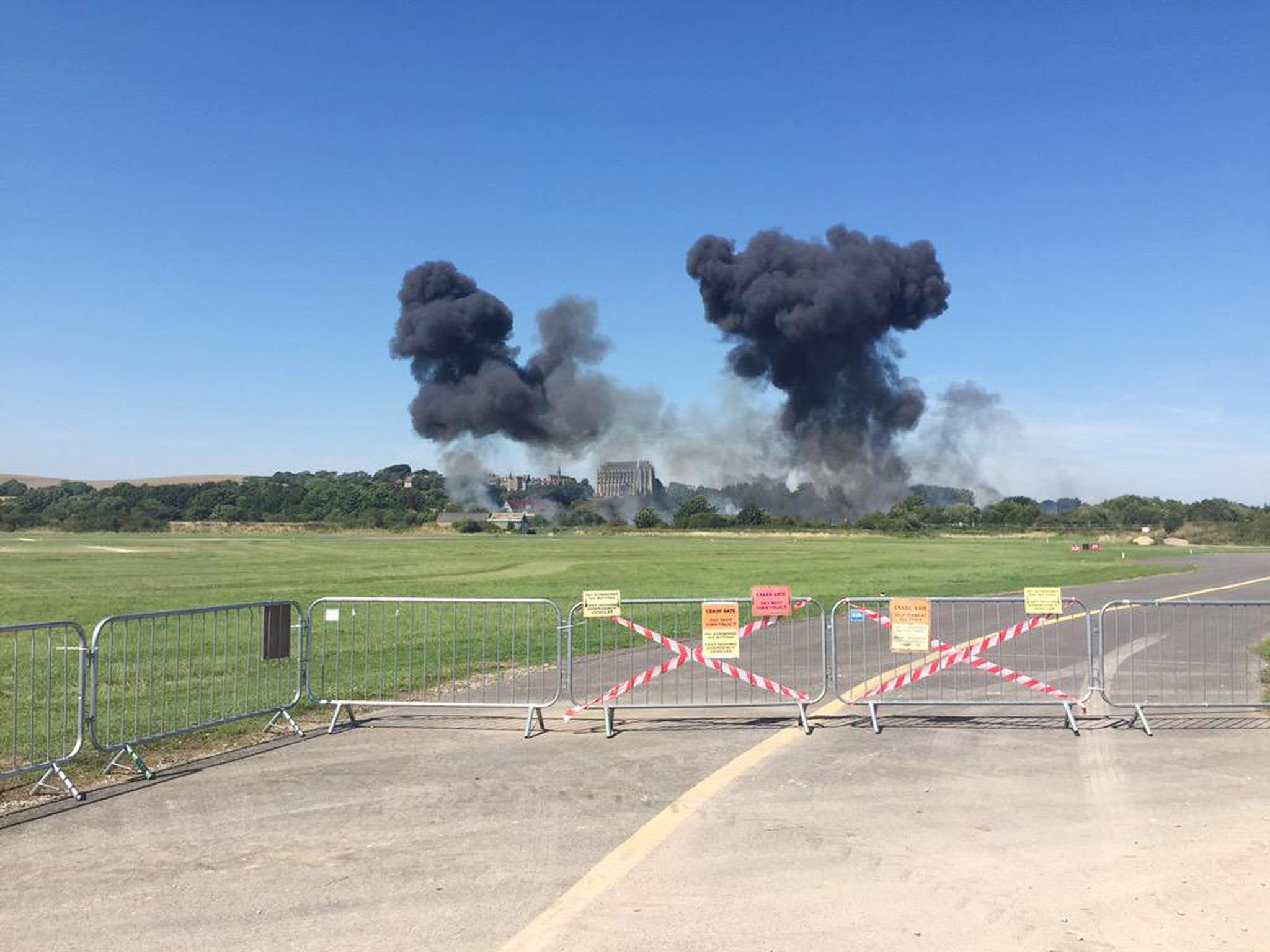 Smoke rises from the scene of the crash (PA)
