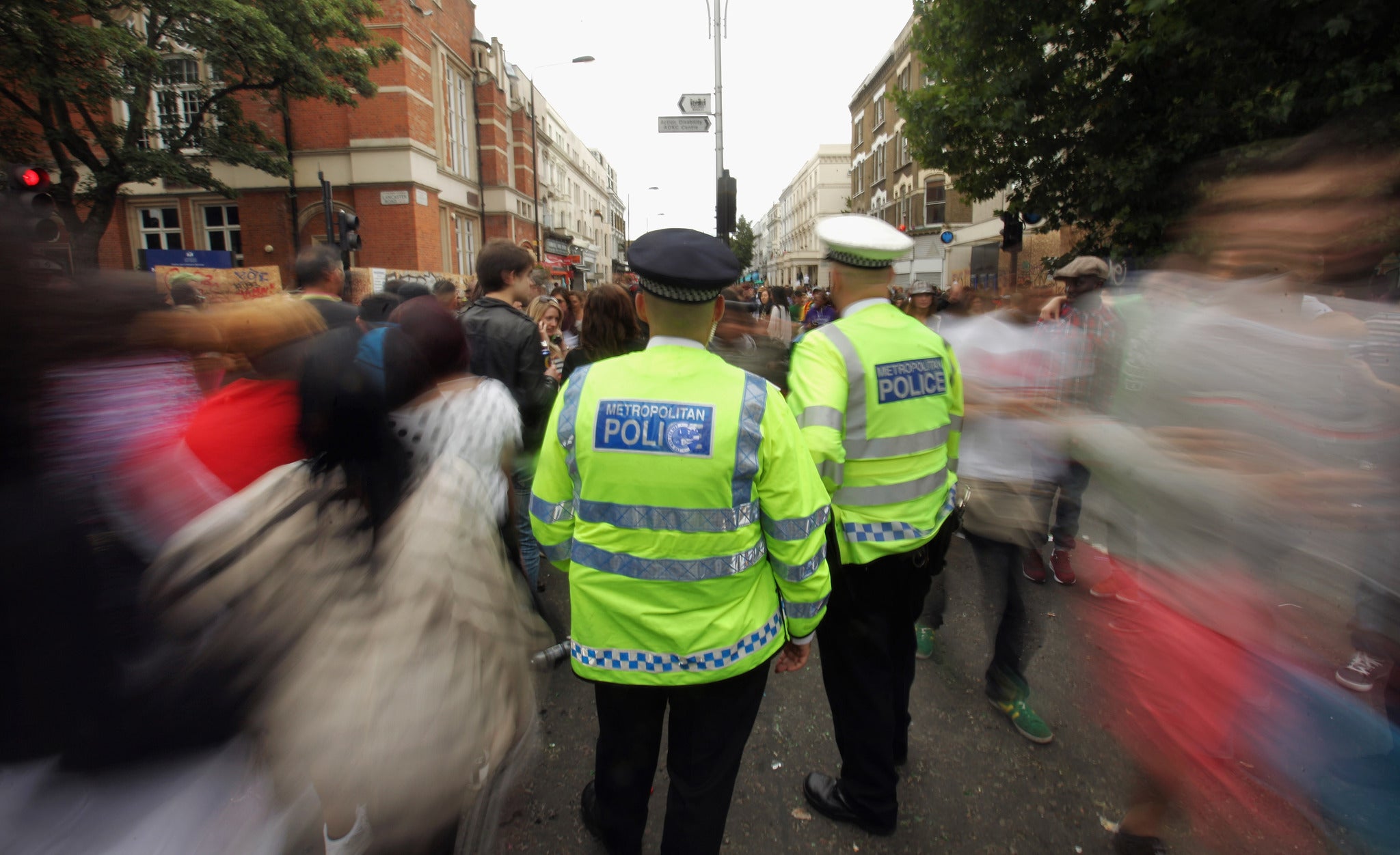 Police officers monitor the crowds at the Notting Hill Carnival on August 29, 2011 in London, England