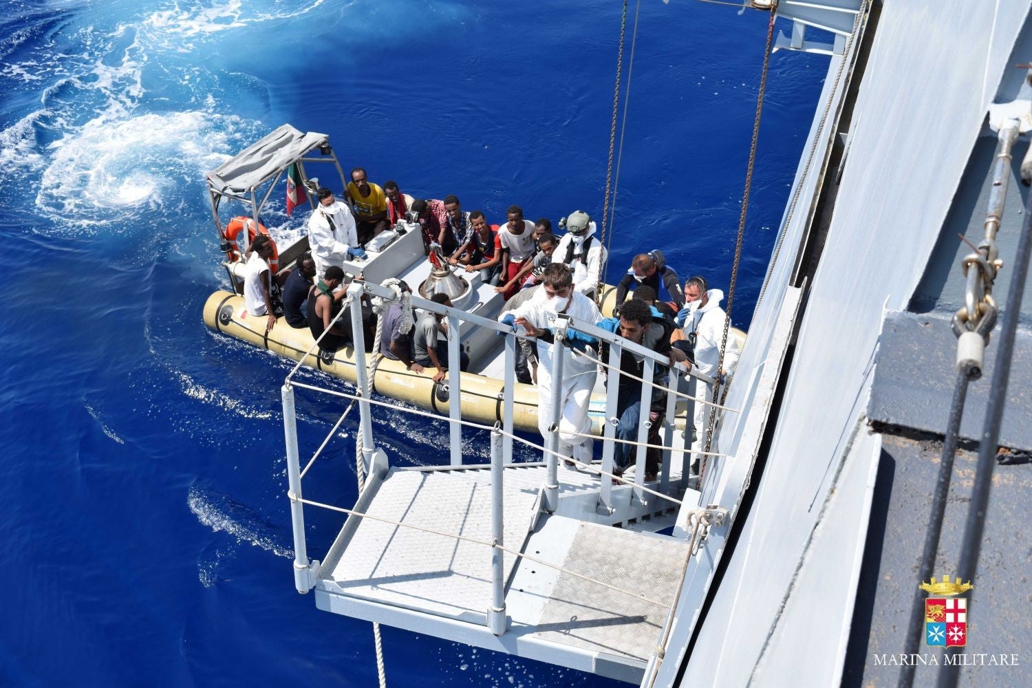 Migrants board the Italian Navy ship Cigala Fulgosi after being rescued