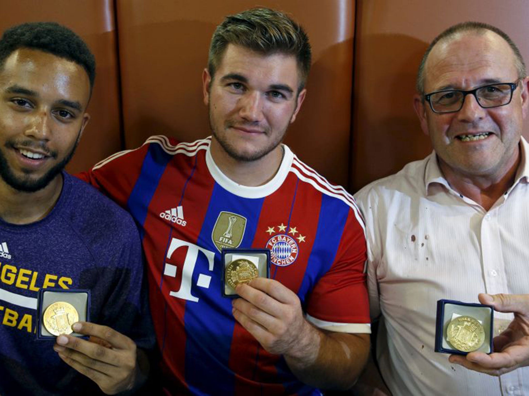 Anthony Sadler, Alek Skarlatos and Chris Norman pose with bravery medals from the mayor of Arras