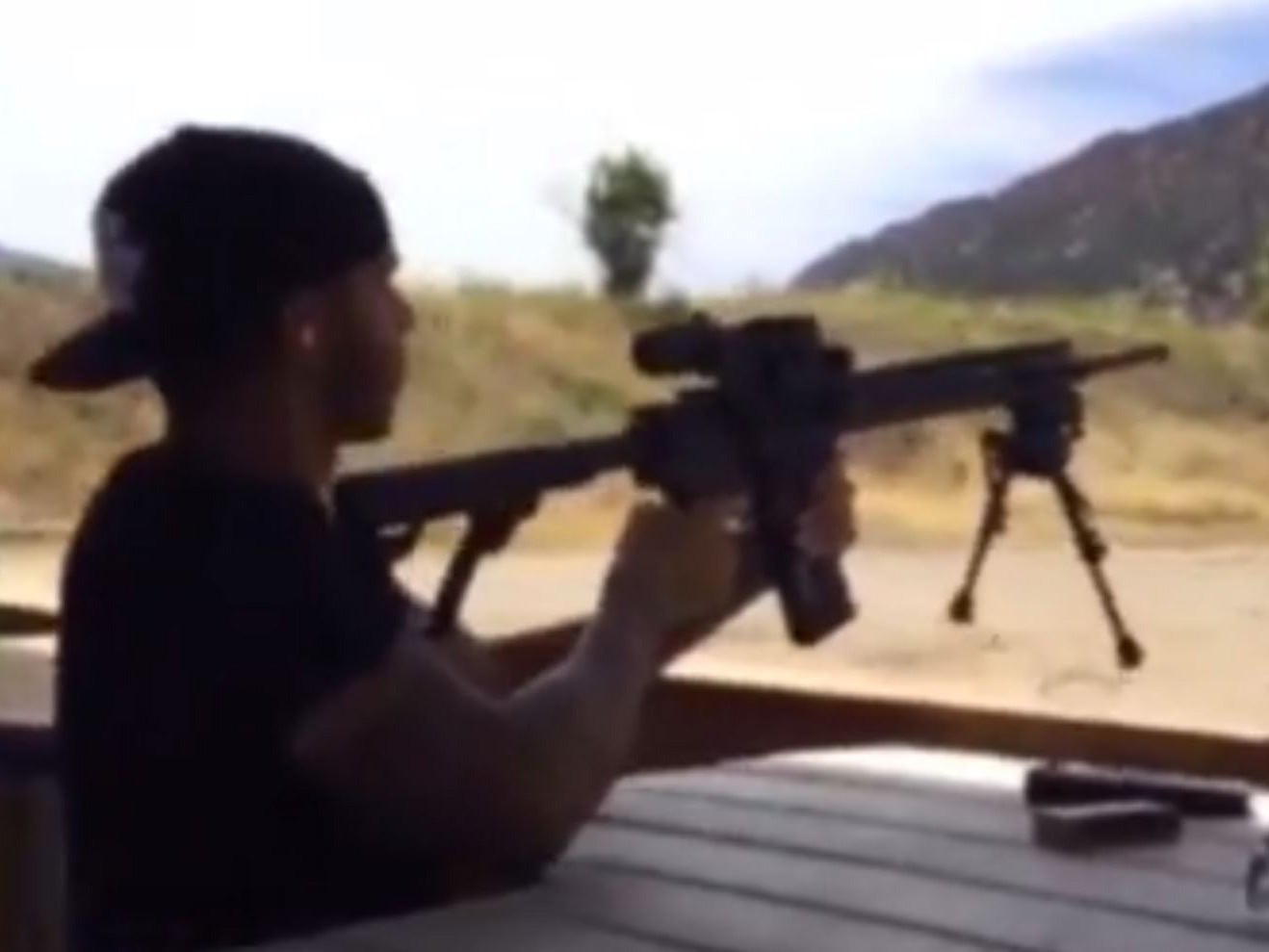 Lewis Hamilton shooting an AK-47 in a video on his Instagram account