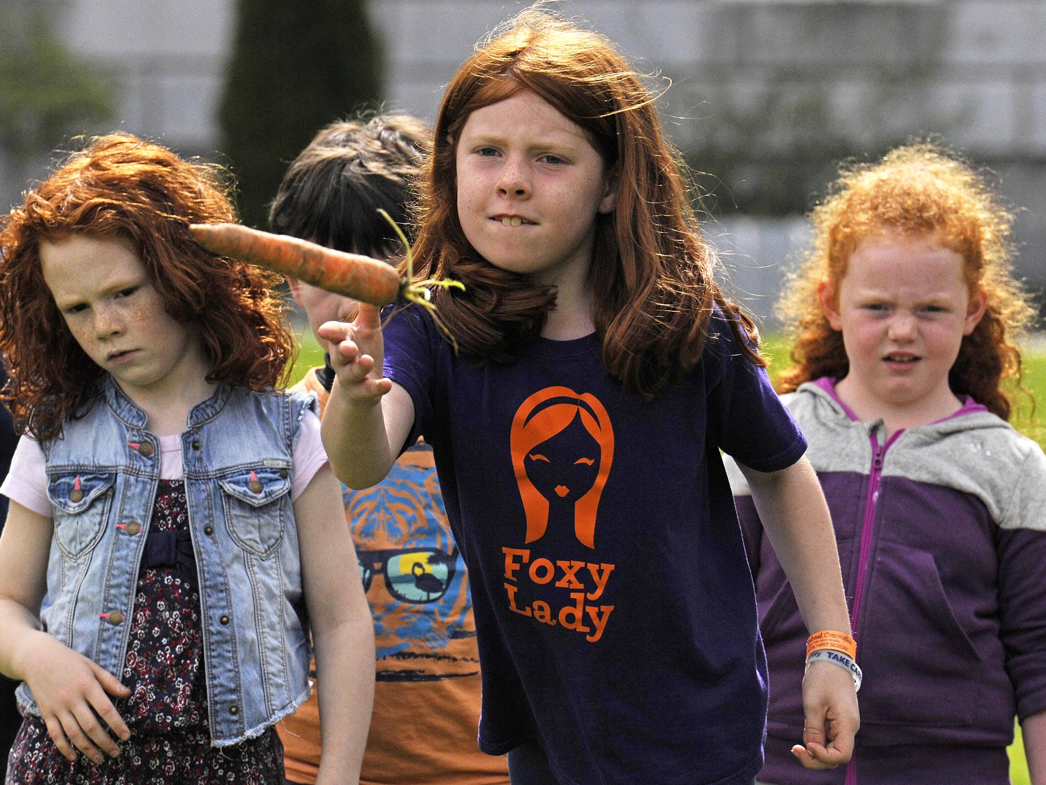 Children participate in the carrot throwing competition